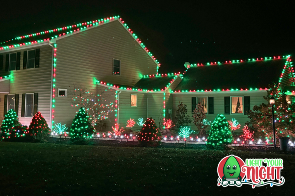 House decked out in green and red Christmas lights